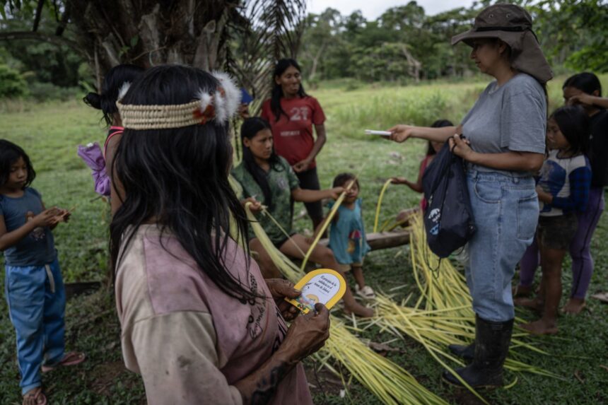 Waorani community members engaged in daily activities within their Amazon rainforest settlement.