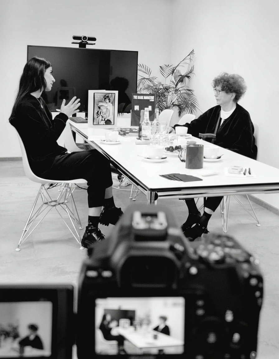 Black and white photo of artist Vera Mercer in conversation with journalist Fatemeh Roshan from The Game Magazine during their interview.