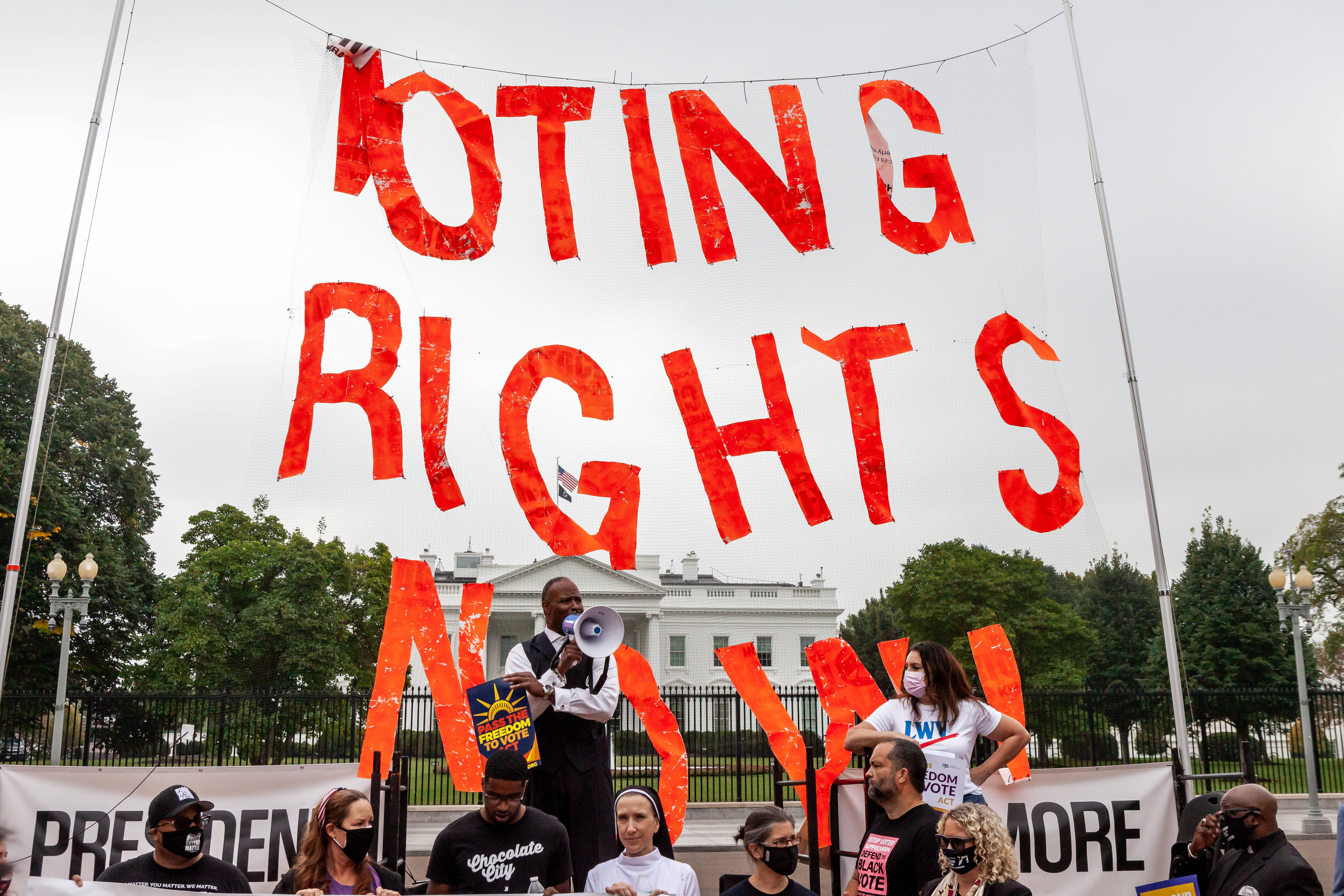 IMAGO / NurPhoto / Allison Bailey | Pastor Lewis Logan of Georgia speaks during a rally for voting rights in front of the White House on October 5, 2021.