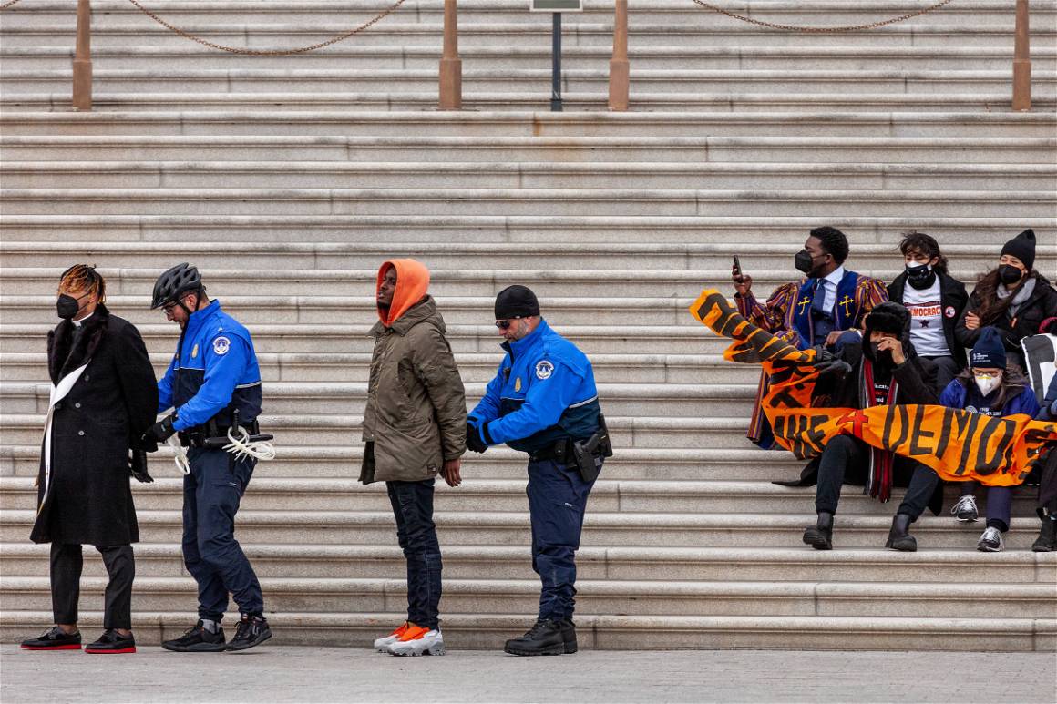 IMAGO / NurPhoto / Allison Bailey | Protesters getting arrested for sitting in a permitted area on the Senate steps in Washington DC. January 18, 2022.