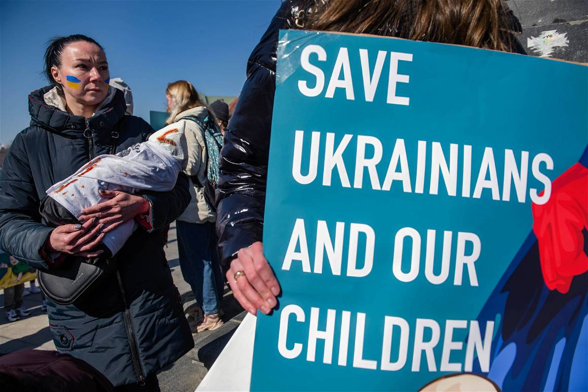 IMAGO / ZUMA Wire / Attila Husejnow. 18 March 2022. Warsaw, Poland. A Ukrainian woman holds a placard saying Save Ukrainians and our children during the protest.