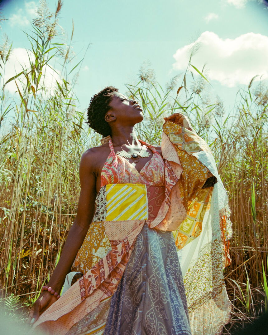 USA, New York, Young fashionable woman in grassy field.