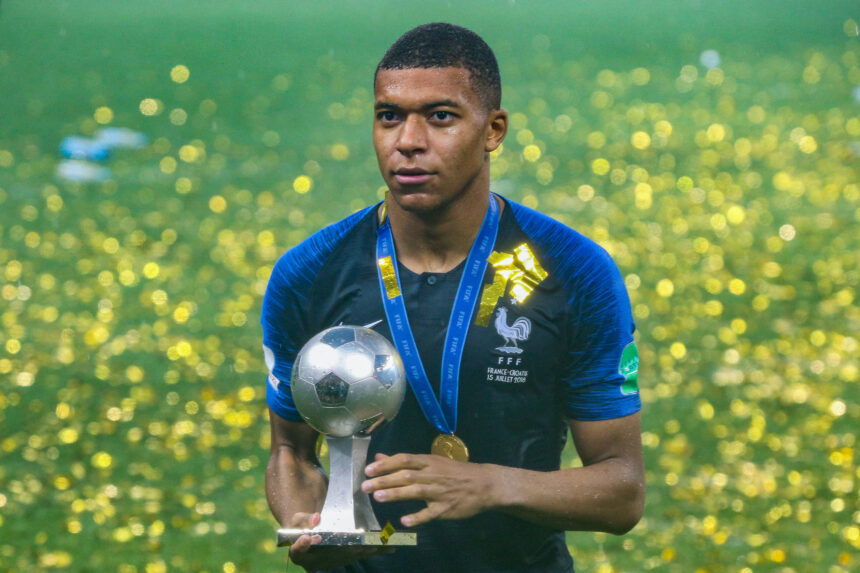 photo of Kylian Mbappé with world cup trophy