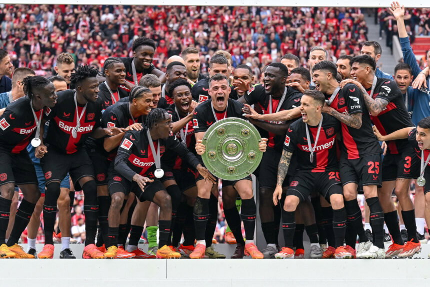 Bayer 04 Leverkusen holds the championship trophy
