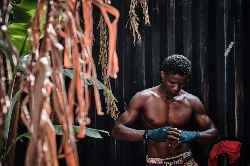 Dera, from the Boîte Noire club in Diego, northern Madagascar, checks his bandages as he prepares for his fight during the Moraingy Iarivo event