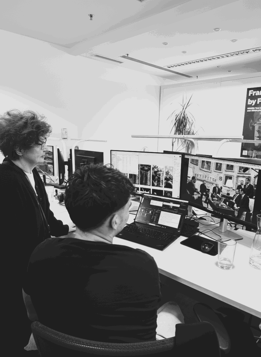 Artist Vera Mercer looking at images on a computer screen during her visit to the IMAGO photo agency office.